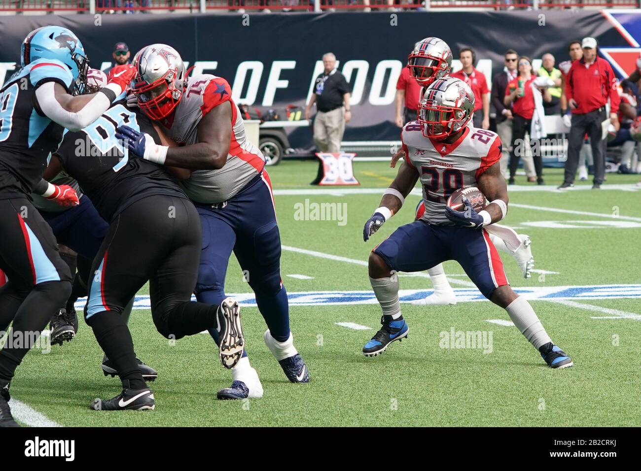 Arlington, United States. 01st Mar, 2020. Houston Roughnecks running back James Butler (28) attempts to find an opening in the line behind the blocking of offensive lineman Avery Gennesy (74) during an XFL football game, Sunday, Mar. 1, 2020, in Arlington, Tex. The Roughnecks defeated the Renegades 27-20. (Wayne Gooden/Image of Sport) Photo via Credit: Newscom/Alamy Live News Stock Photo