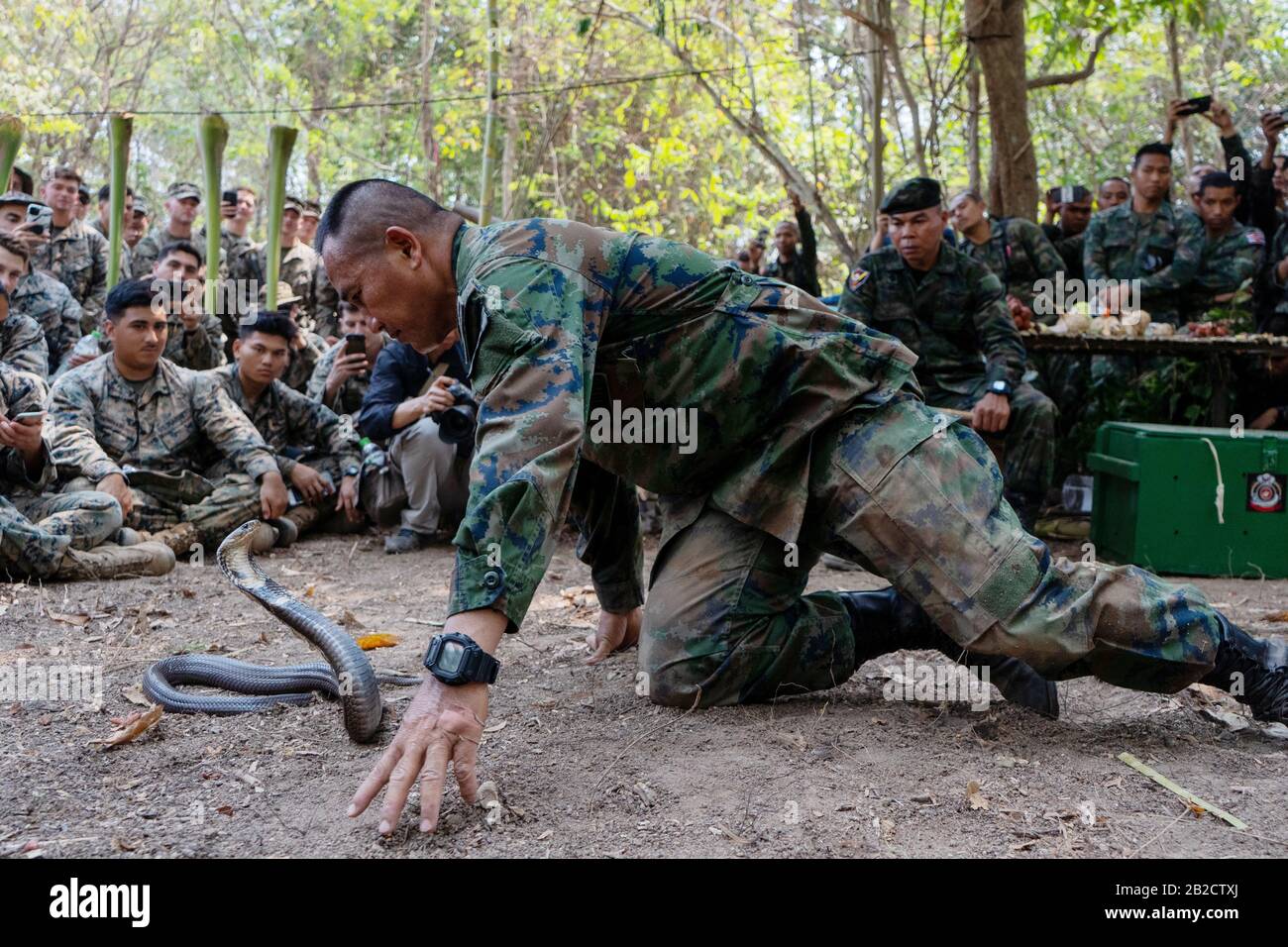Ban Chan Khrem, Thailand. 02nd Mar, 2020. Royal Thai Marine CPO First Class Pairoj Prasarnsai demonstrates how to handle a king cobra as part of jungle survival training during exercise Cobra Gold 2020 March 2, 2020 in Ban Chan Khrem, Chanthaburi, Thailand. The Marines learned essential skills necessary for surviving in a jungle environment, such as making a fire, eating plants and alternative ways to stay hydrated. Credit: Nicolas Cholula/Planetpix/Alamy Live News Credit: Planetpix/Alamy Live News Stock Photo