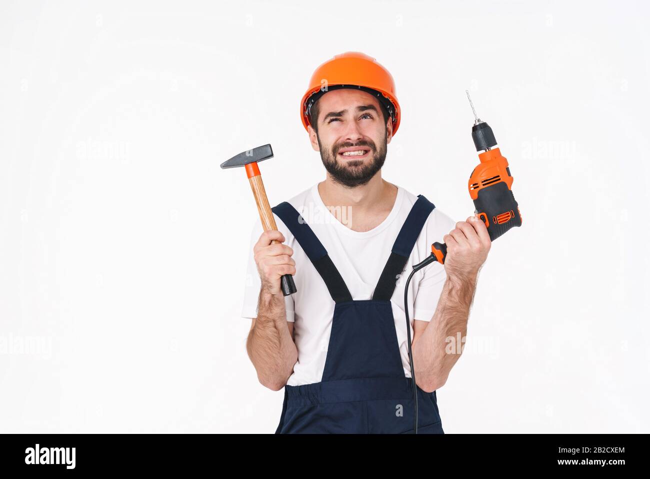 Man builder confused holding hammer hi-res stock photography and images ...