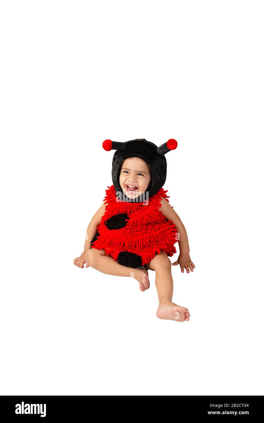Toddler wearing ladybug costume playing happy smiling fun activity isolated white background Stock Photo