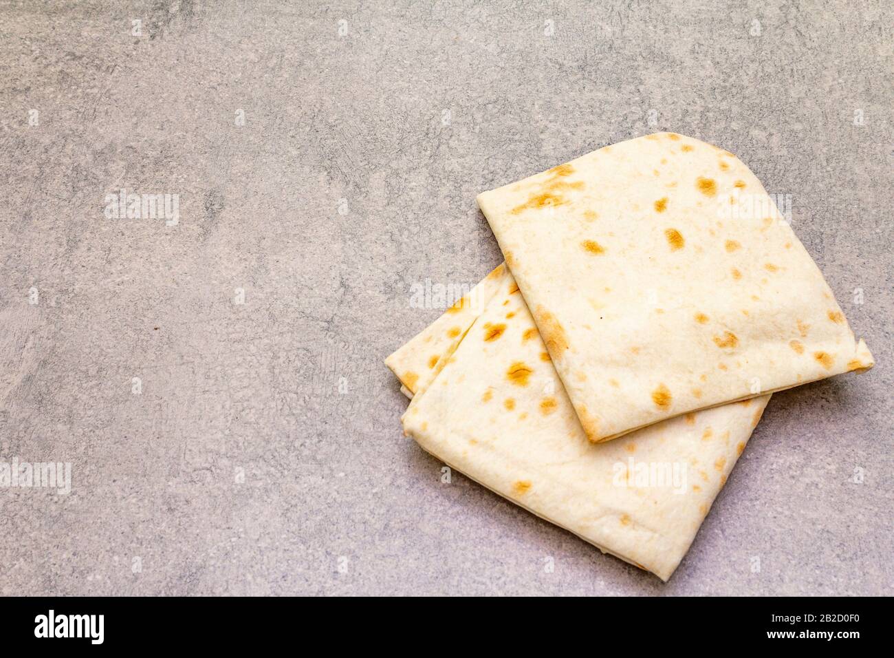 Pita bread lavash on a stone background. Food cooking background
