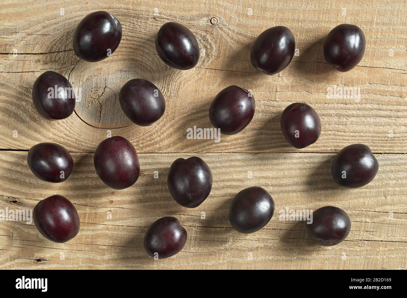 Plums on wooden background, top view Stock Photo