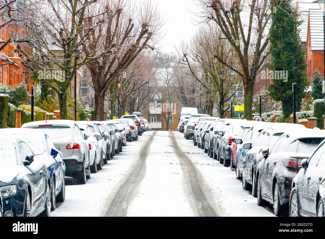 Terraced street covered with snow around West Hampstead area in London while snowing and sleeting Stock Photo