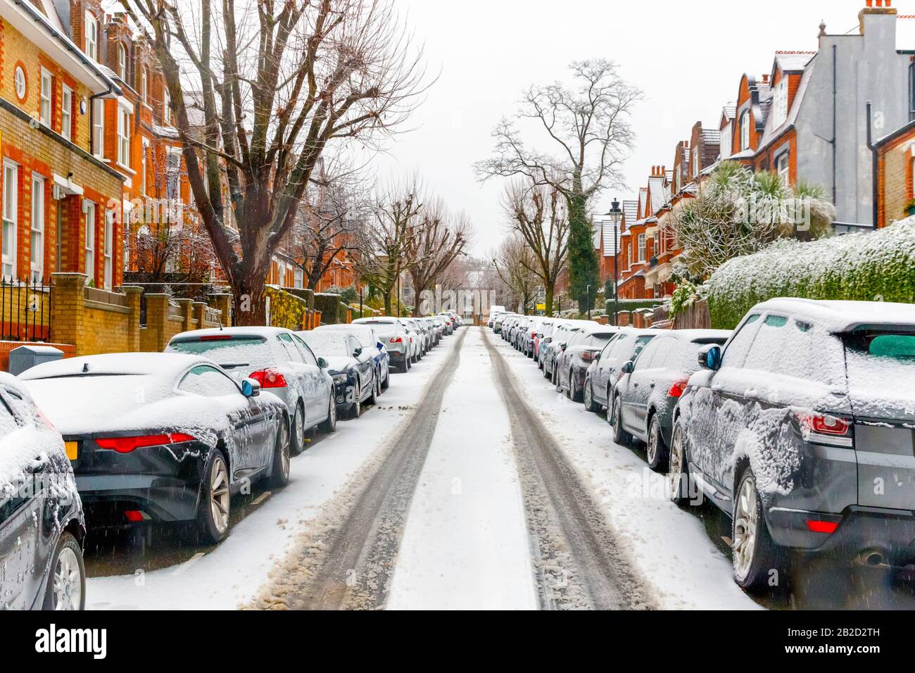 Terraced street covered with snow around West Hampstead area in London while snowing and sleeting Stock Photo