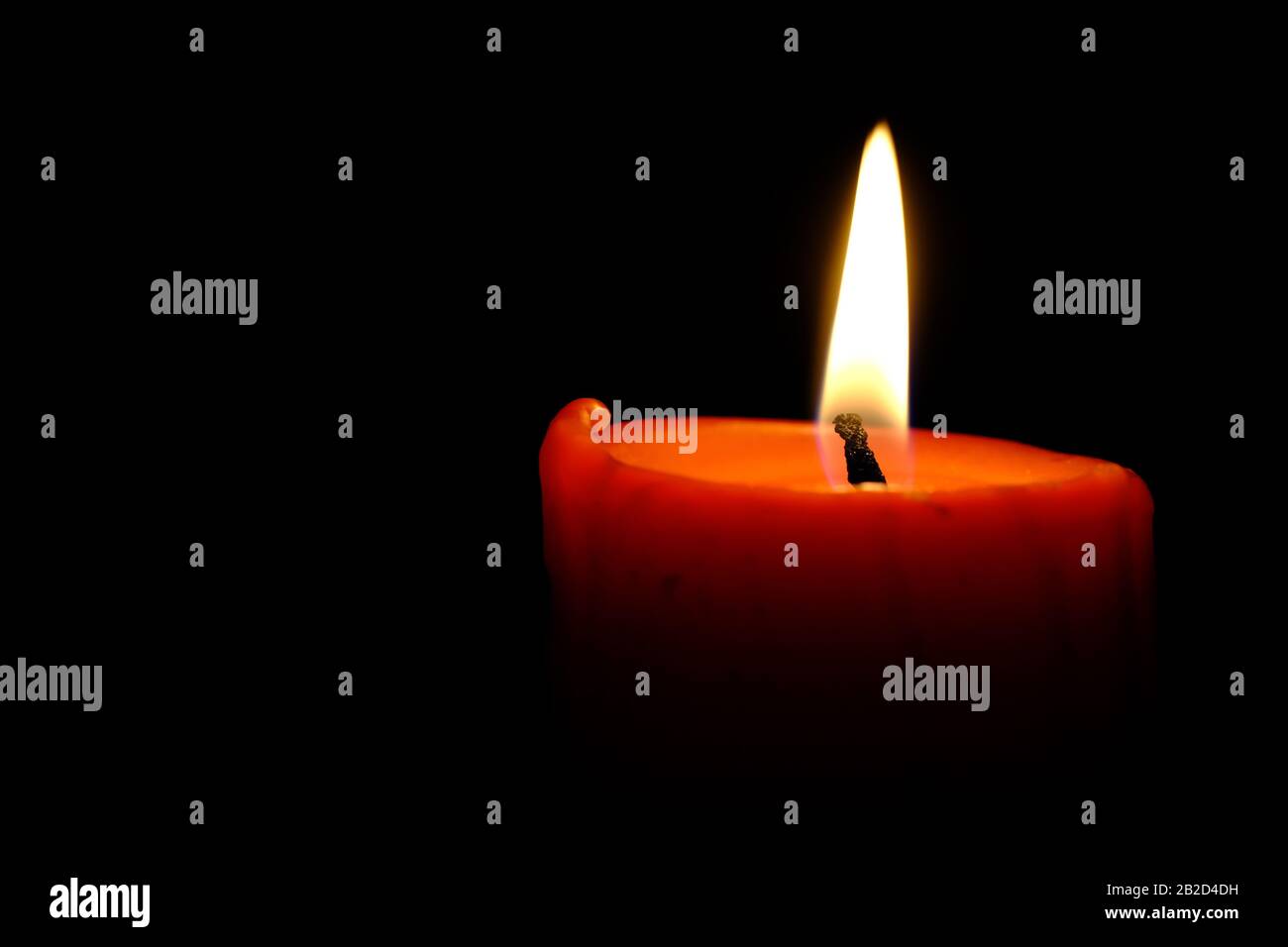 Close up of burning colorful candle at night, praying  Stock Photo