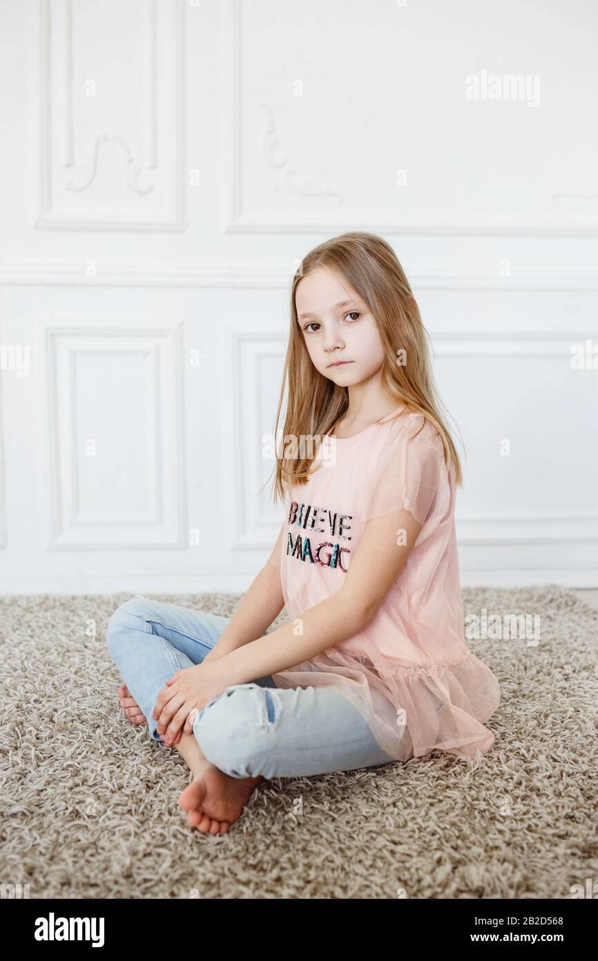 https://c8.alamy.com/comp/2B2D568/cute-pre-teen-girl-wearing-fashion-clothes-posing-in-white-interior-little-but-very-serious-girl-2B2D568.jpg
