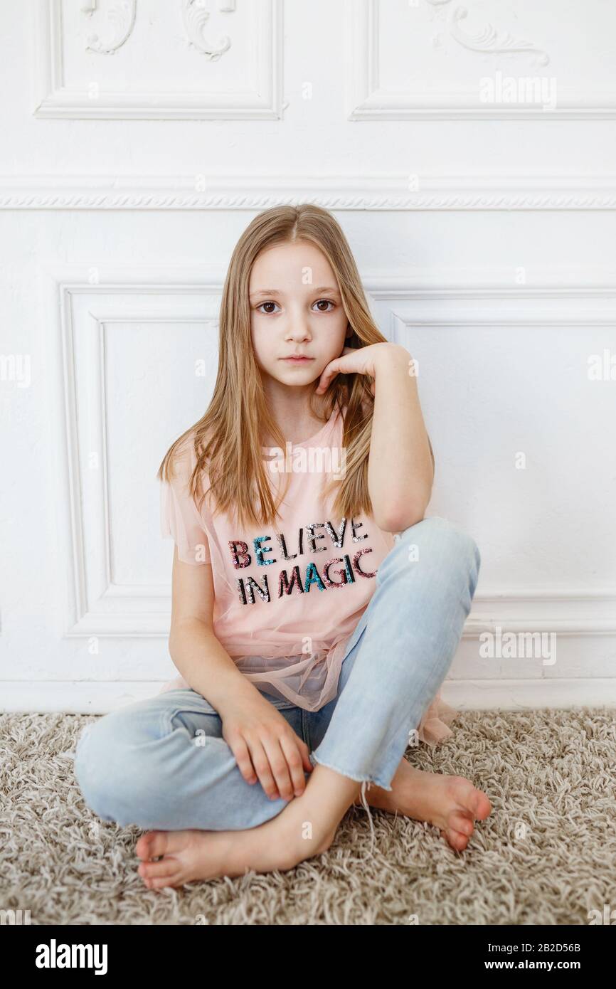 Cute Pre Teen Girl Wearing Fashion Clothes Posing In White Interior Little But Very Serious