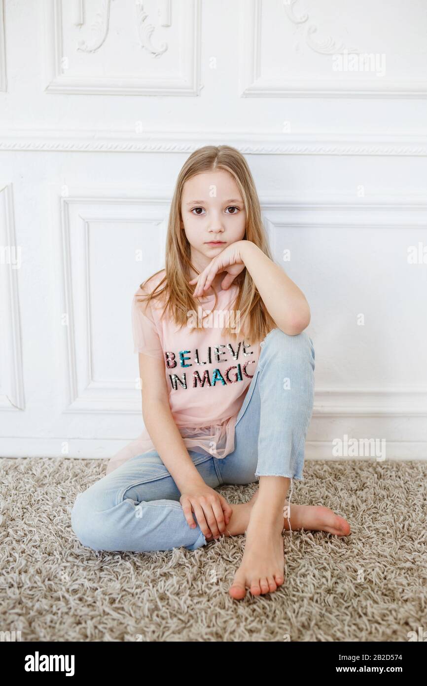 Cute Pre Teen Girl Wearing Fashion Clothes Posing In White Interior Little But Very Serious