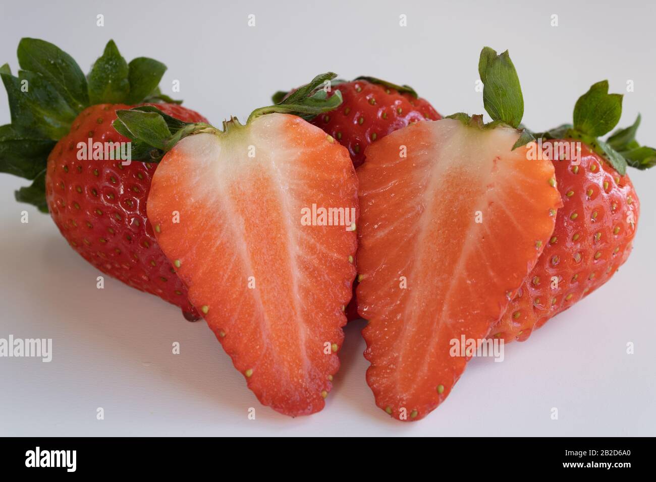 group of strawberries isolated on white background whole and broken Stock Photo