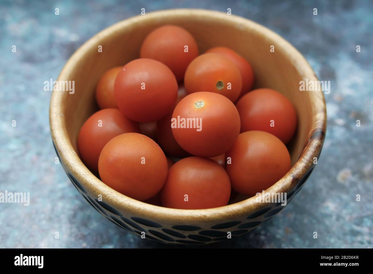Close up of cherry tomato in a bowl on table  Stock Photo