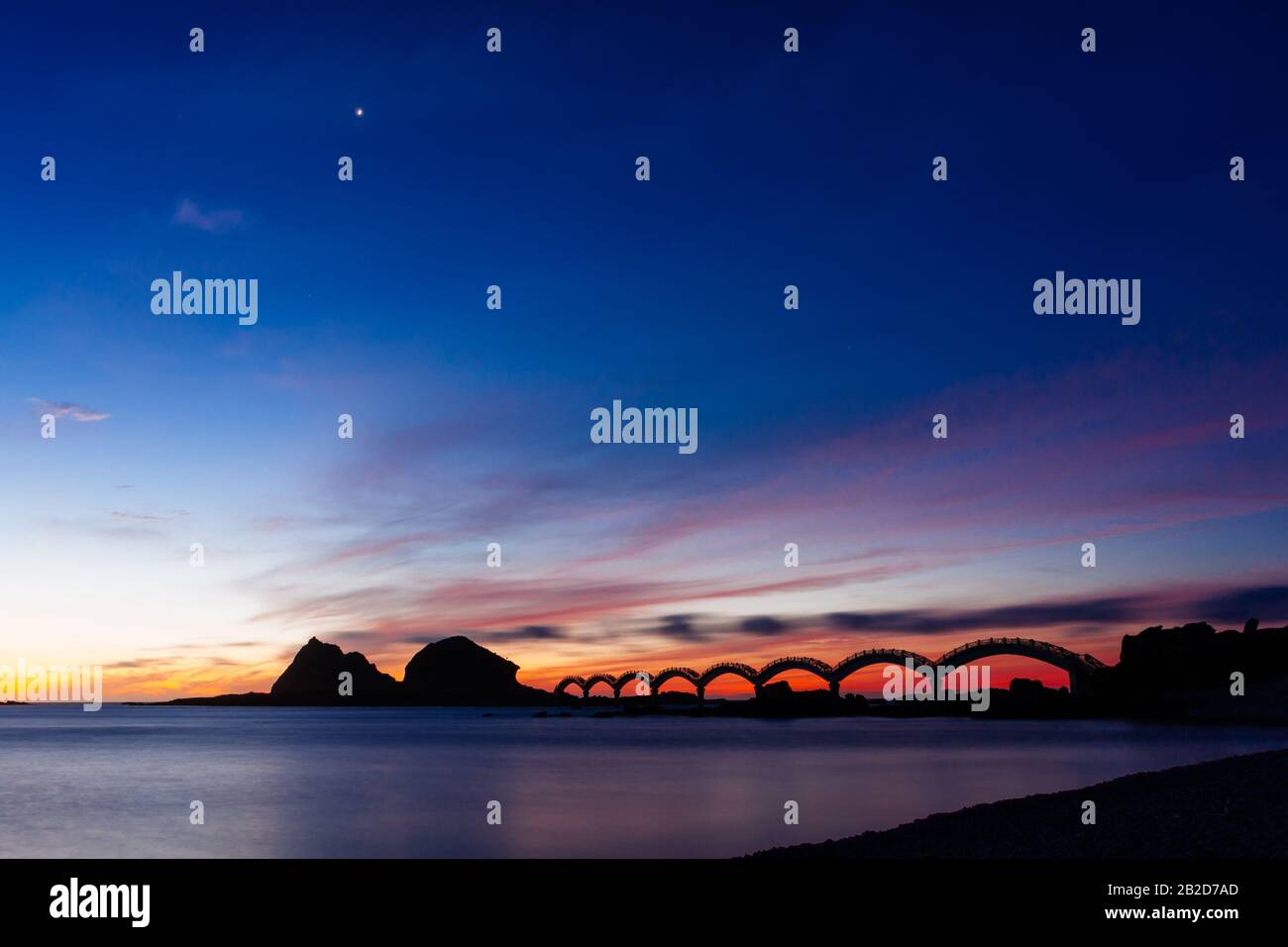 A small island off the coast and the iconic eight-arch footbridge ...