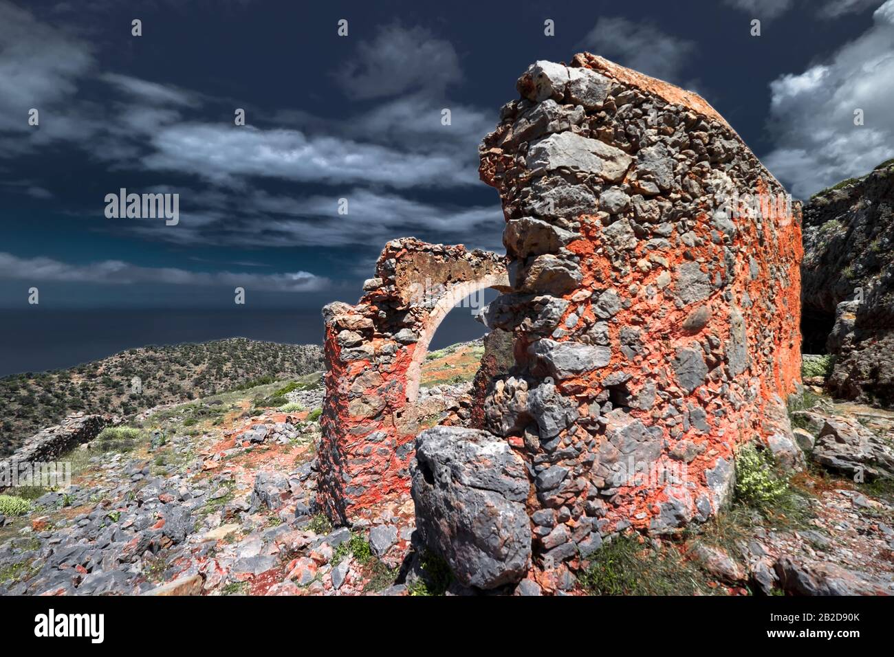 Abstract ruins of abandoned old temple Crete island. Greece. Stone construction under dark sky. Dramatic view of ancient landmark. Apocalyptic and evi Stock Photo
