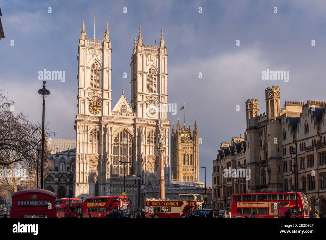 Red London buses at Westminster Abbeyl after rain, London,England Stock Photo
