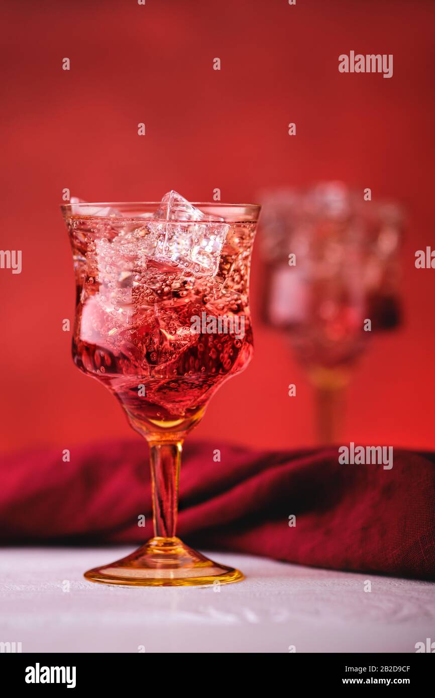Soft focus photo of cocktail with gin and pomegranate bitter on red