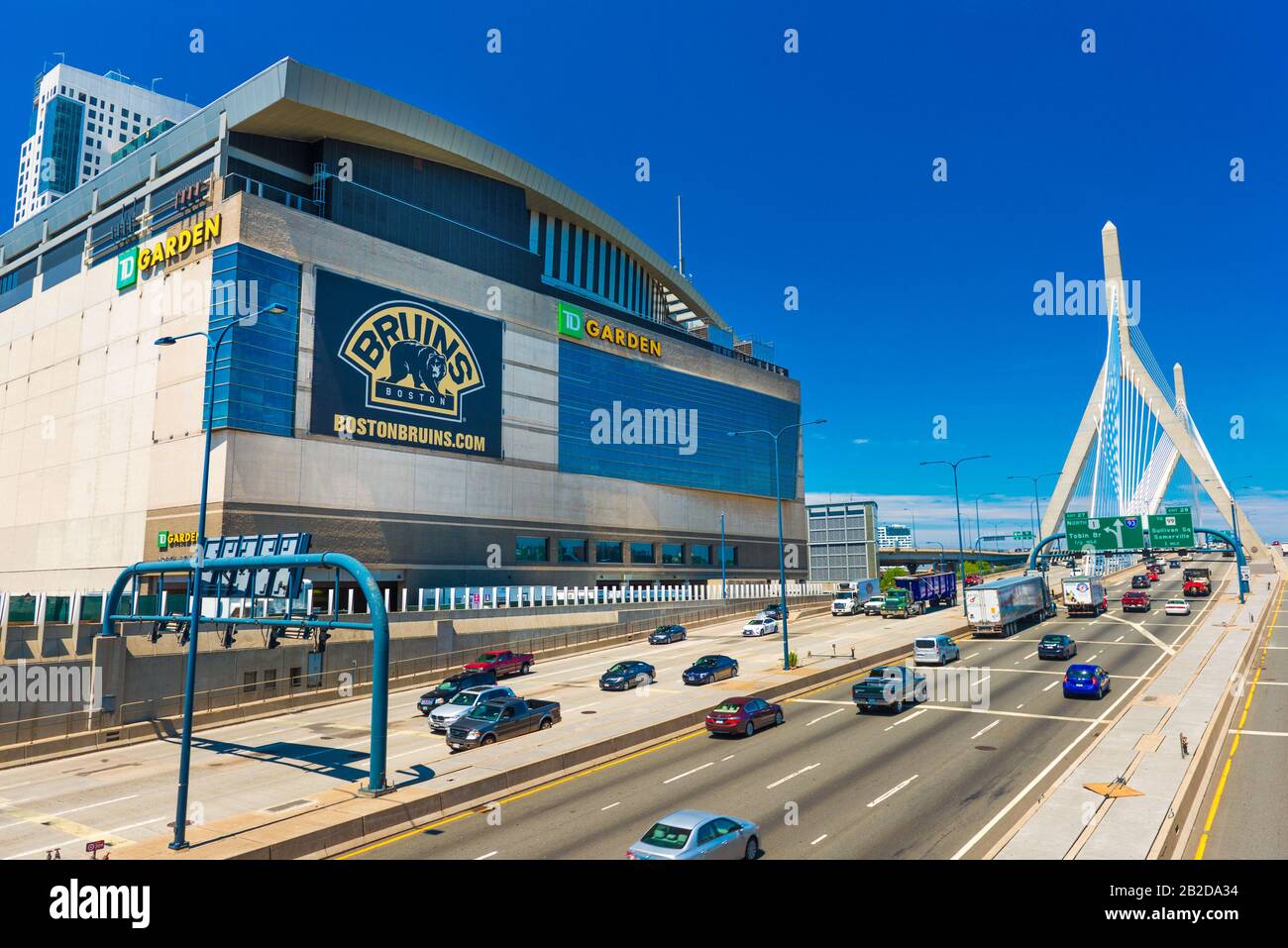 Boston - June 2016, MA, USA: View of TD Garden, Leonard P. Zakim Bunker Hill Bridge and highway with traffic in sunny summer day with clear blue sky Stock Photo