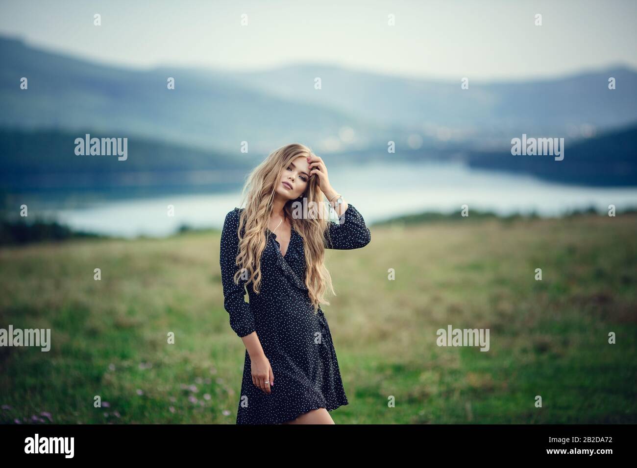 Happy pretty girl in field at sunset. Art photo. Forest and lake. The ...