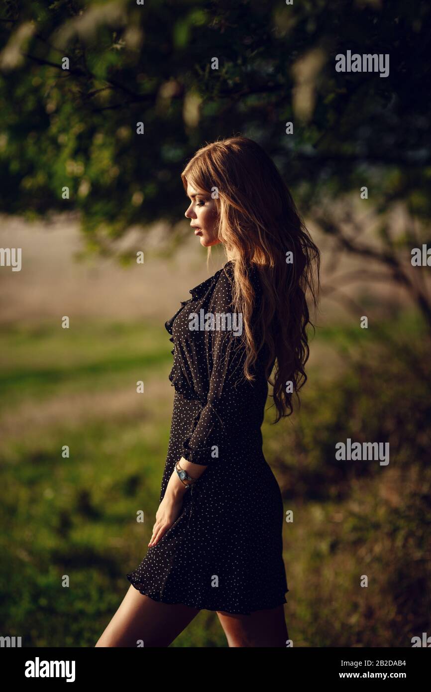 Happy pretty girl in field at sunset. Art photo. Forest and lake. The ...
