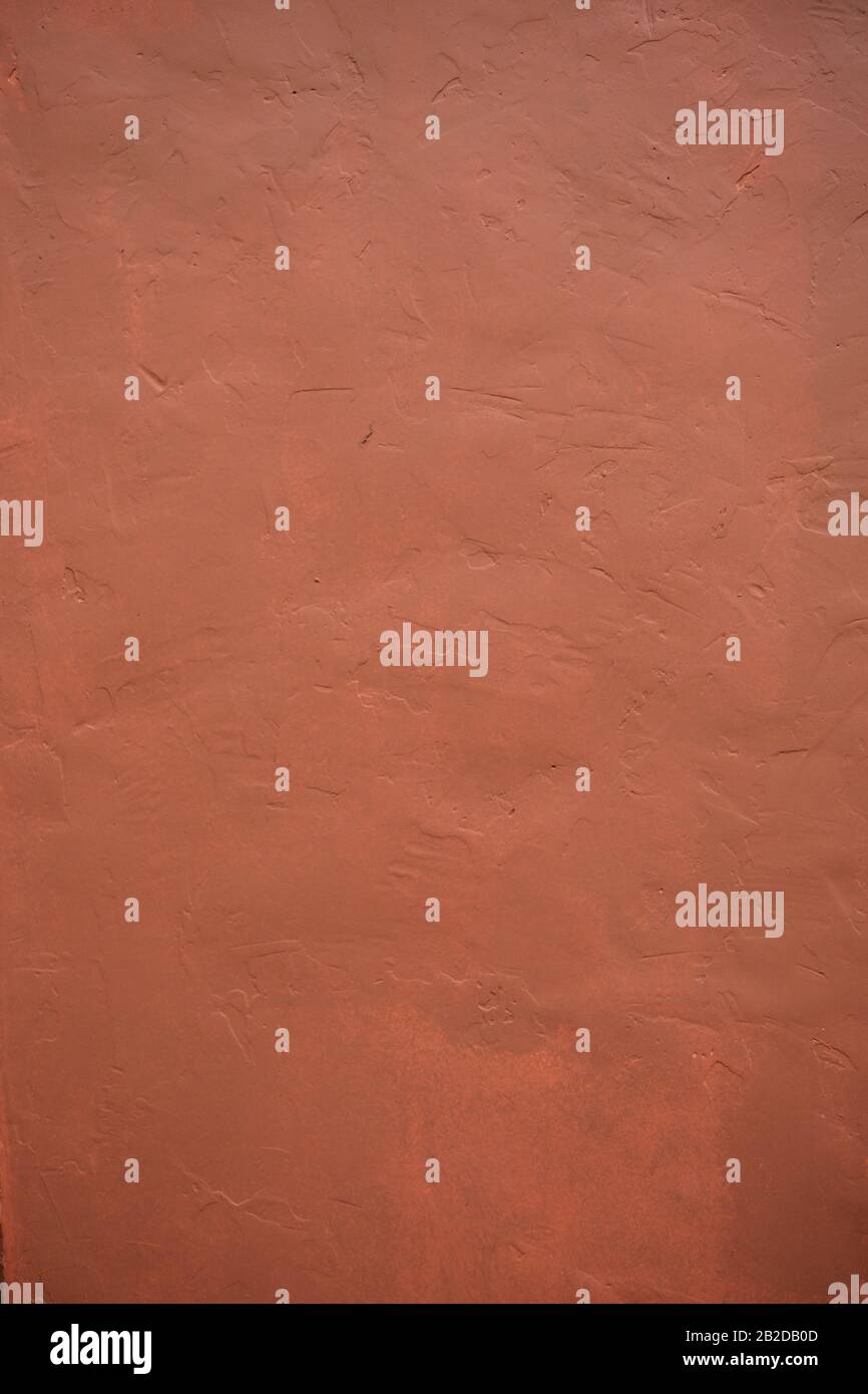 A stone texture wall in pink-brown paint. Stock Photo