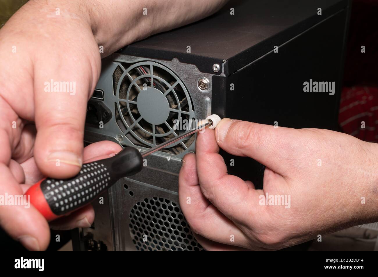 Computer repair. Removing the system unit cover. Dust on the fan, damage to the cooling system Stock Photo