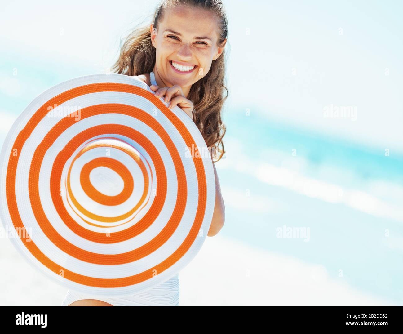 happy young woman in swimsuit with beach hat Stock Photo - Alamy