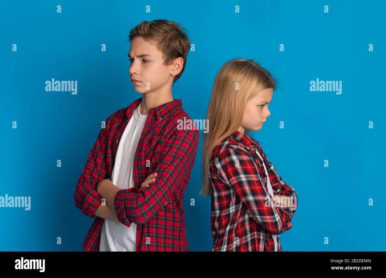 Siblings Misunderstanding. Offended Brother And Sister Ignoring Each Other After Quarrel Stock Photo