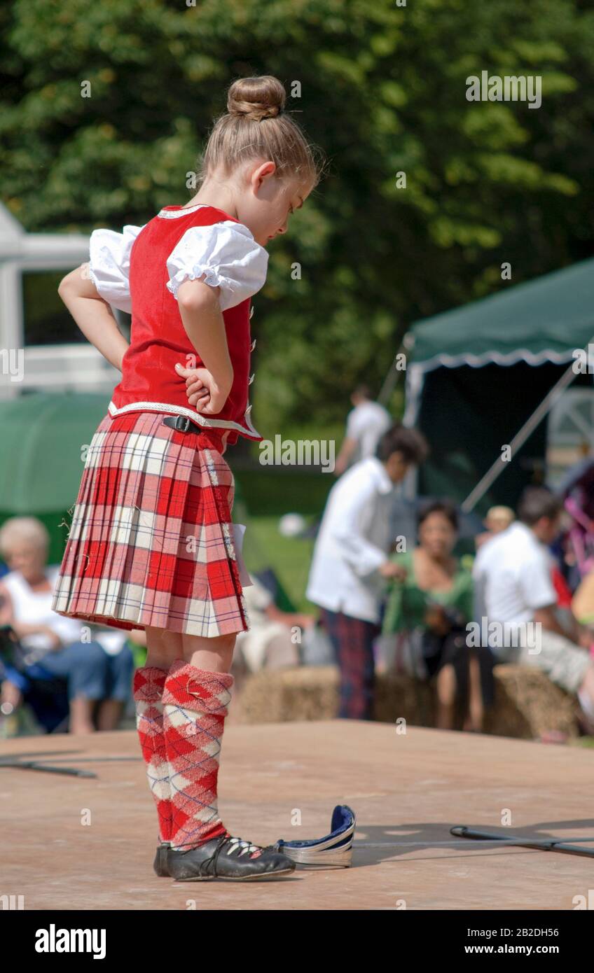 Young Scottish Highland Dancer performing a sword dance during a competition in Colchester, Essex, England Stock Photo