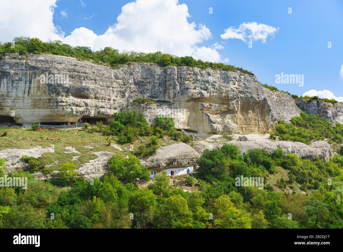 The economic yard of the Holy assumption Orthodox cave monastery in the Crimea, located in the rocky canopy of the natural boundary of Mariam-Dere (Ma Stock Photo