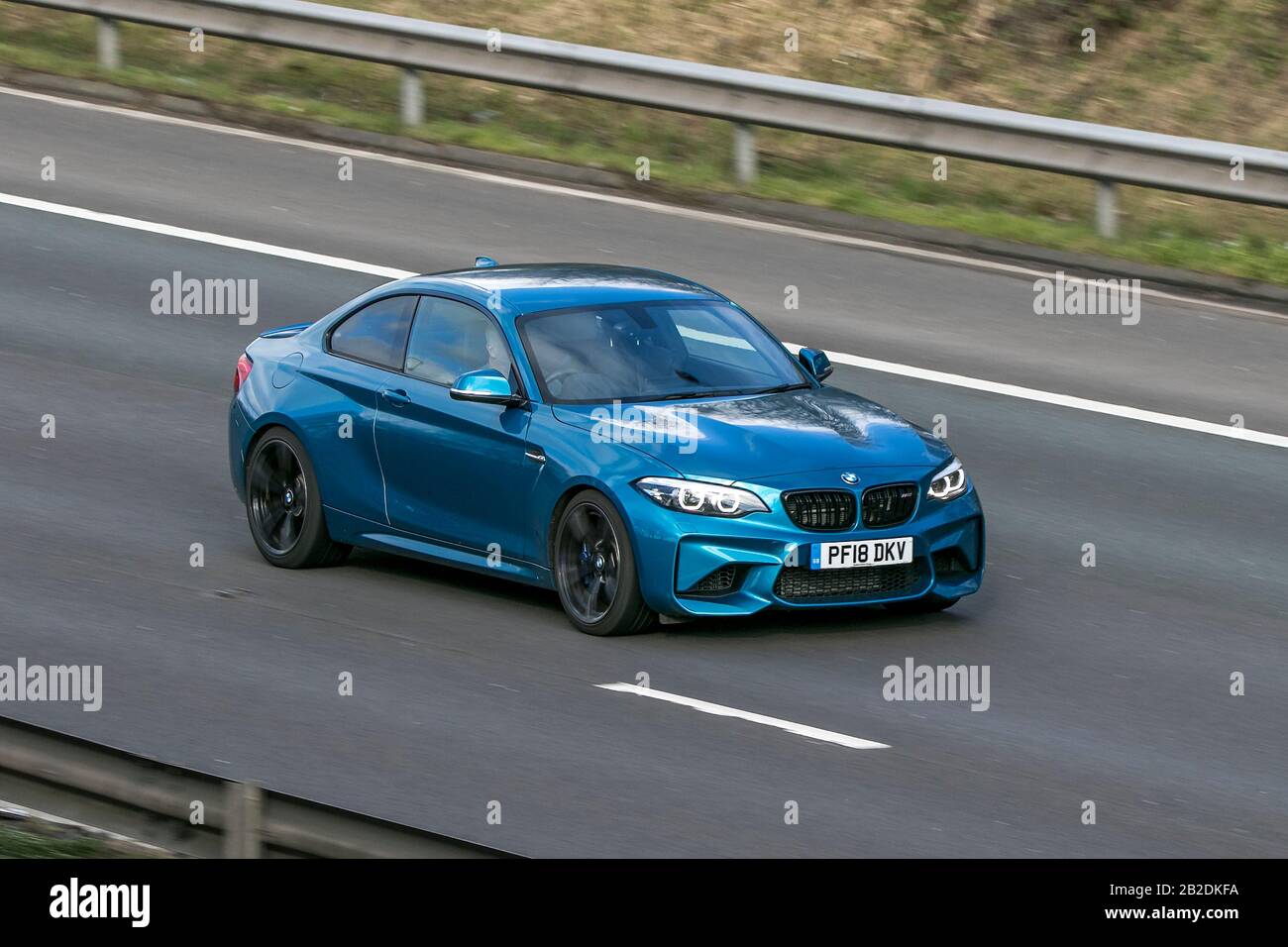 2018 blue BMW M2 Auto; Vehicular traffic, transport, modern vehicles, saloon cars, vehicle on UK roads, luxury motors, motoring on the M6 motorway Stock Photo