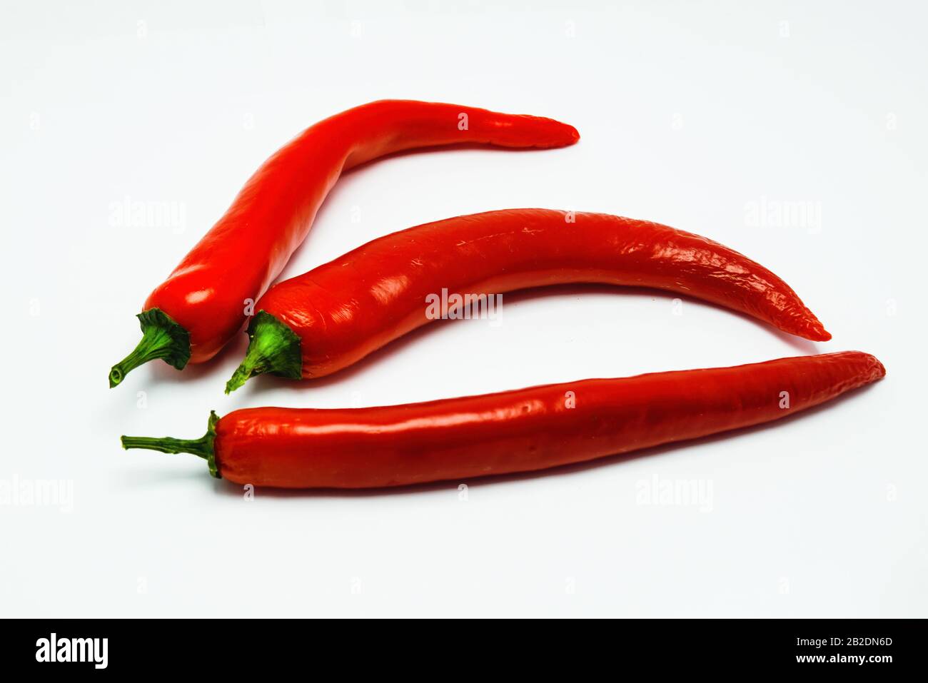 Red chili peppers isolated against a white background Stock Photo - Alamy