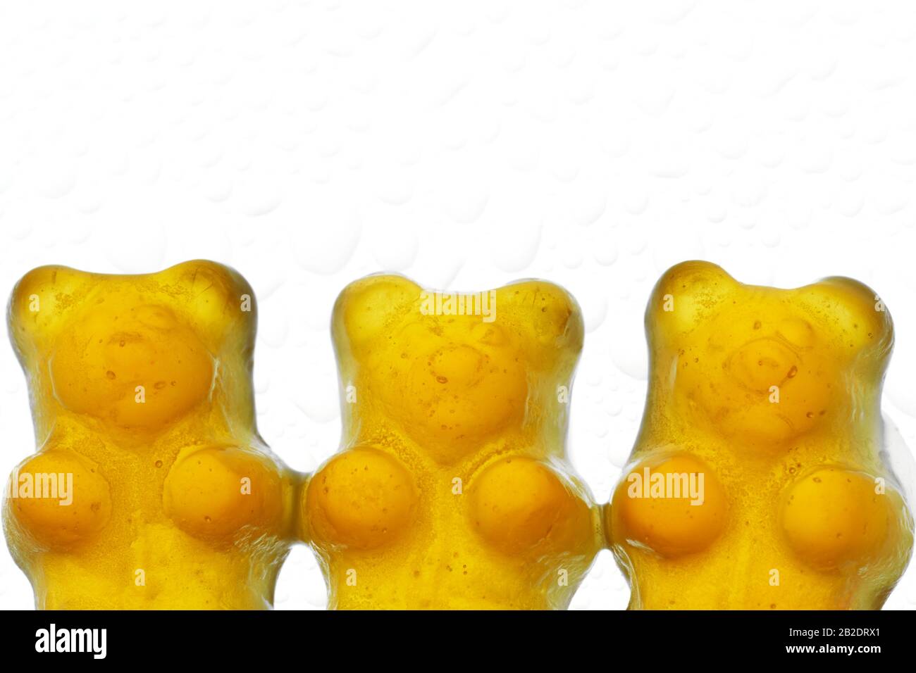 Orange jelly bear candy aligned on a white background Stock Photo
