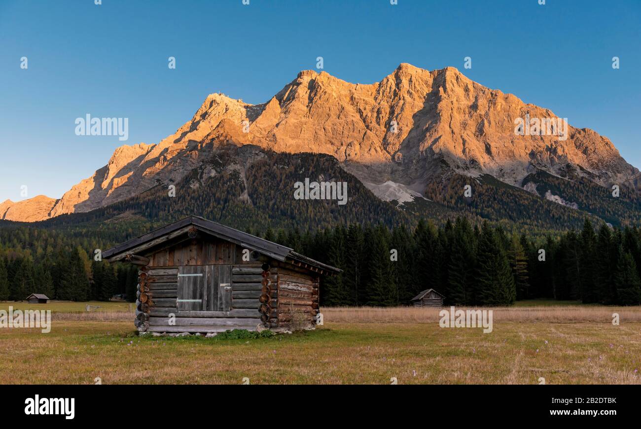 Meadow with Heustadl, sunset at the Zugspitze, Wetterstein range, Werdenfelser Land, Upper Bavaria, Bavaria, Germany Stock Photo