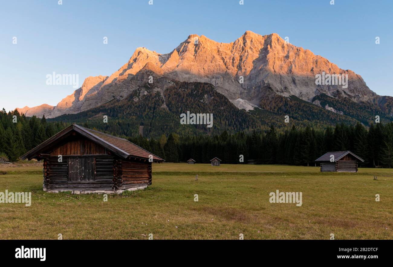 Meadow with Heustadl, sunset at the Zugspitze, Wetterstein range, Werdenfelser Land, Upper Bavaria, Bavaria, Germany Stock Photo
