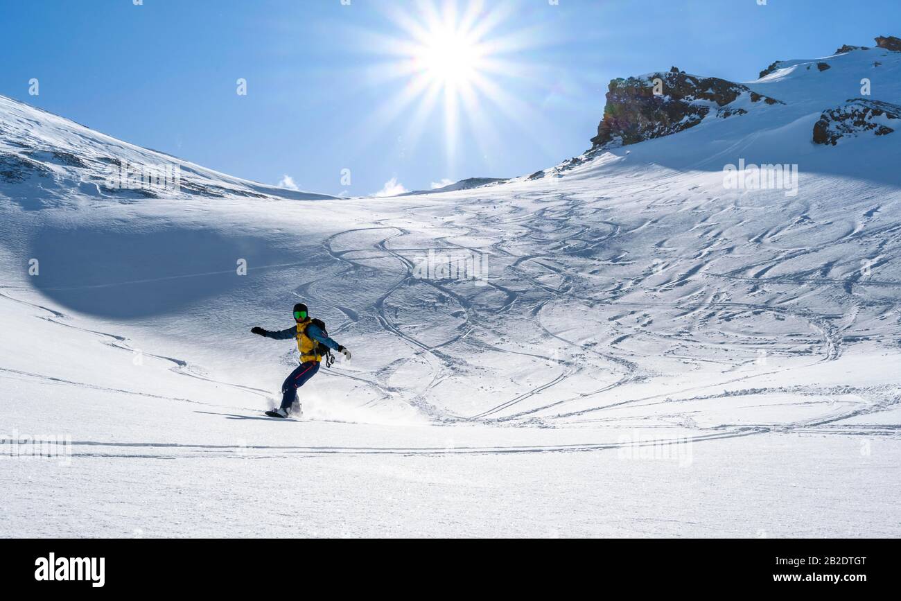 Snowboarder with splitboard rides in the snow, ski tour Geierspitze, Wattentaler Lizum, Tuxer Alps, Tyrol, Austria Stock Photo