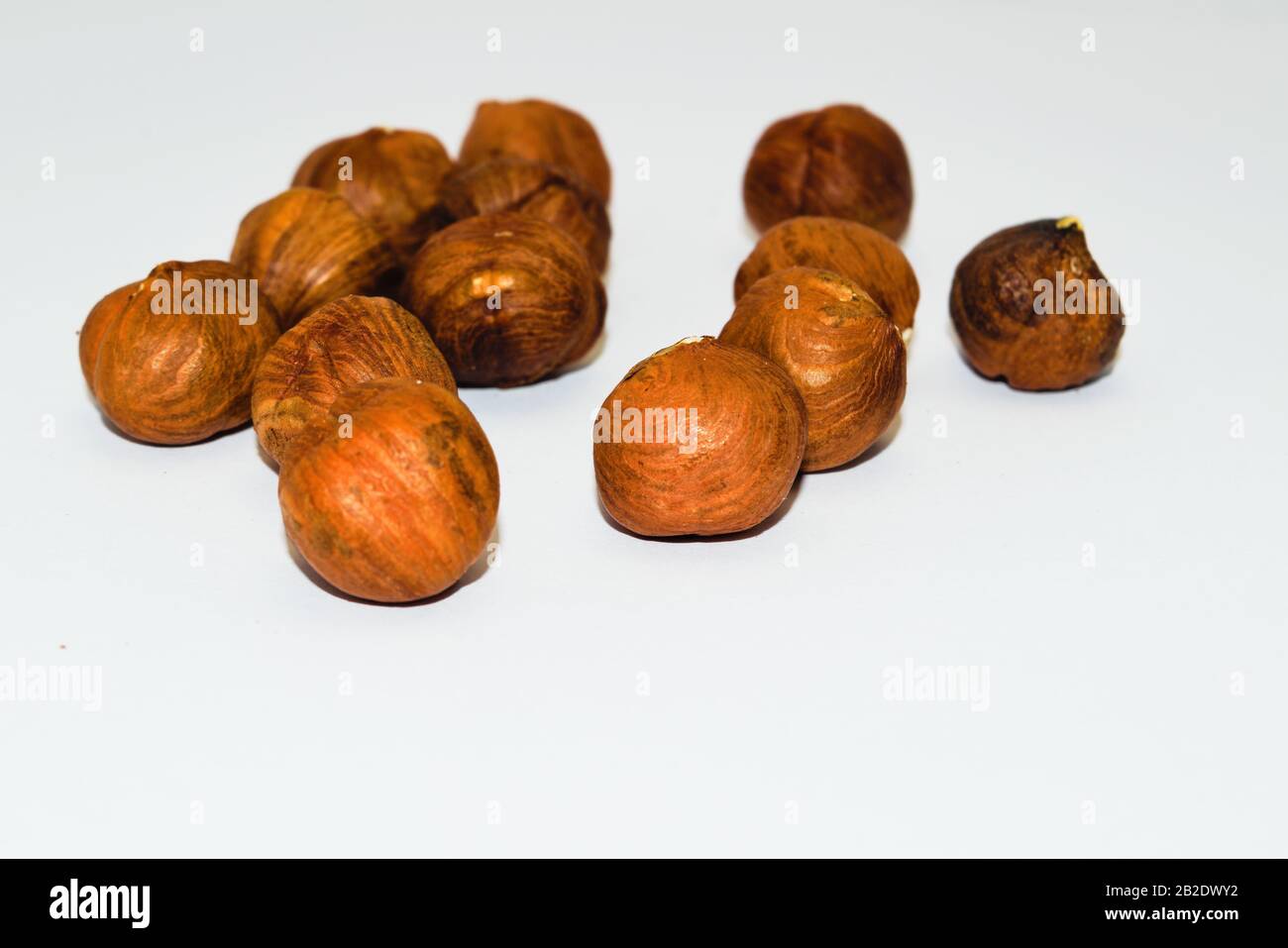 Unshelled hazel nuts isolated on white, food background. Stock Photo