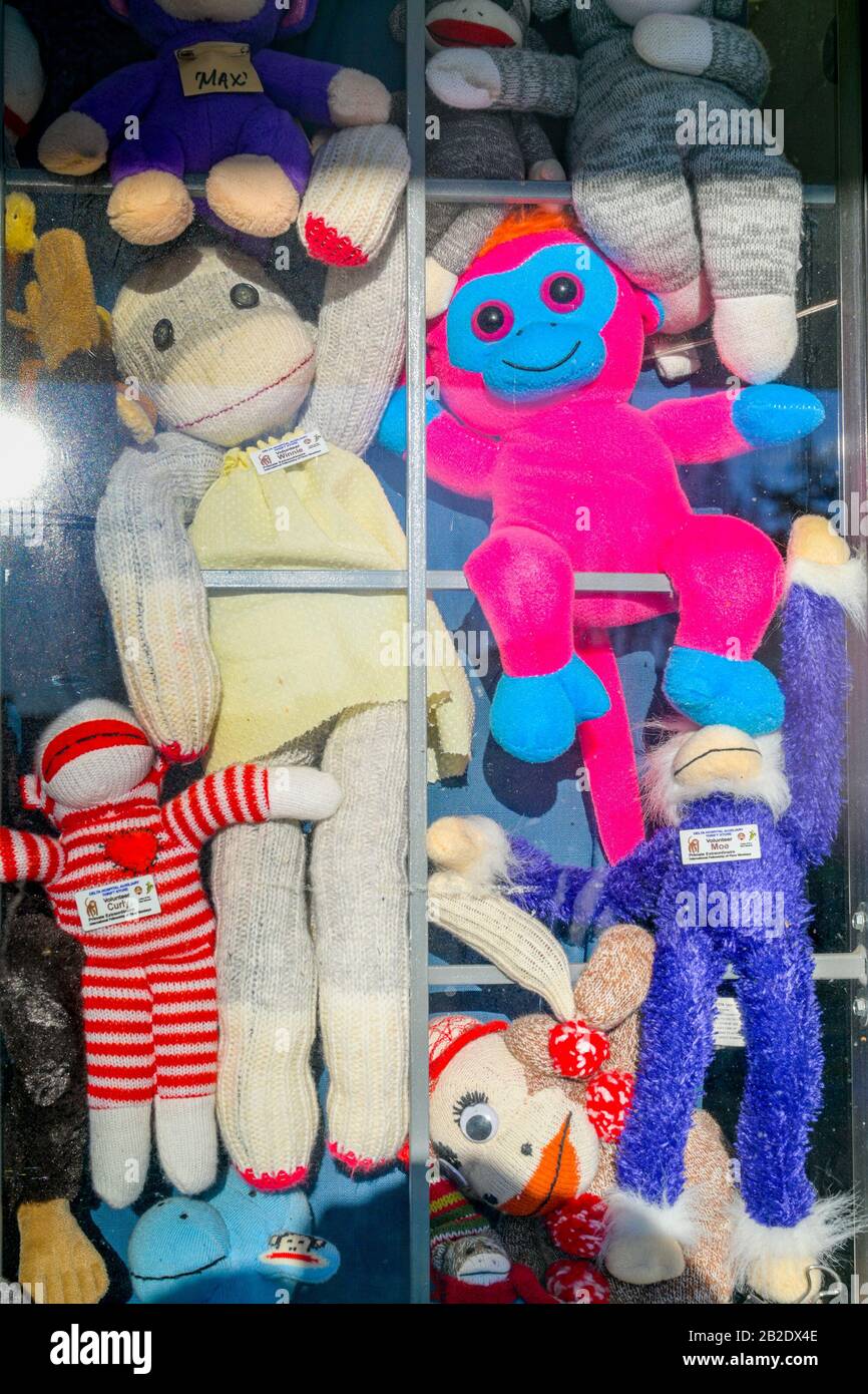 Sock monkey collection, thrift store, window display Stock Photo Alamy