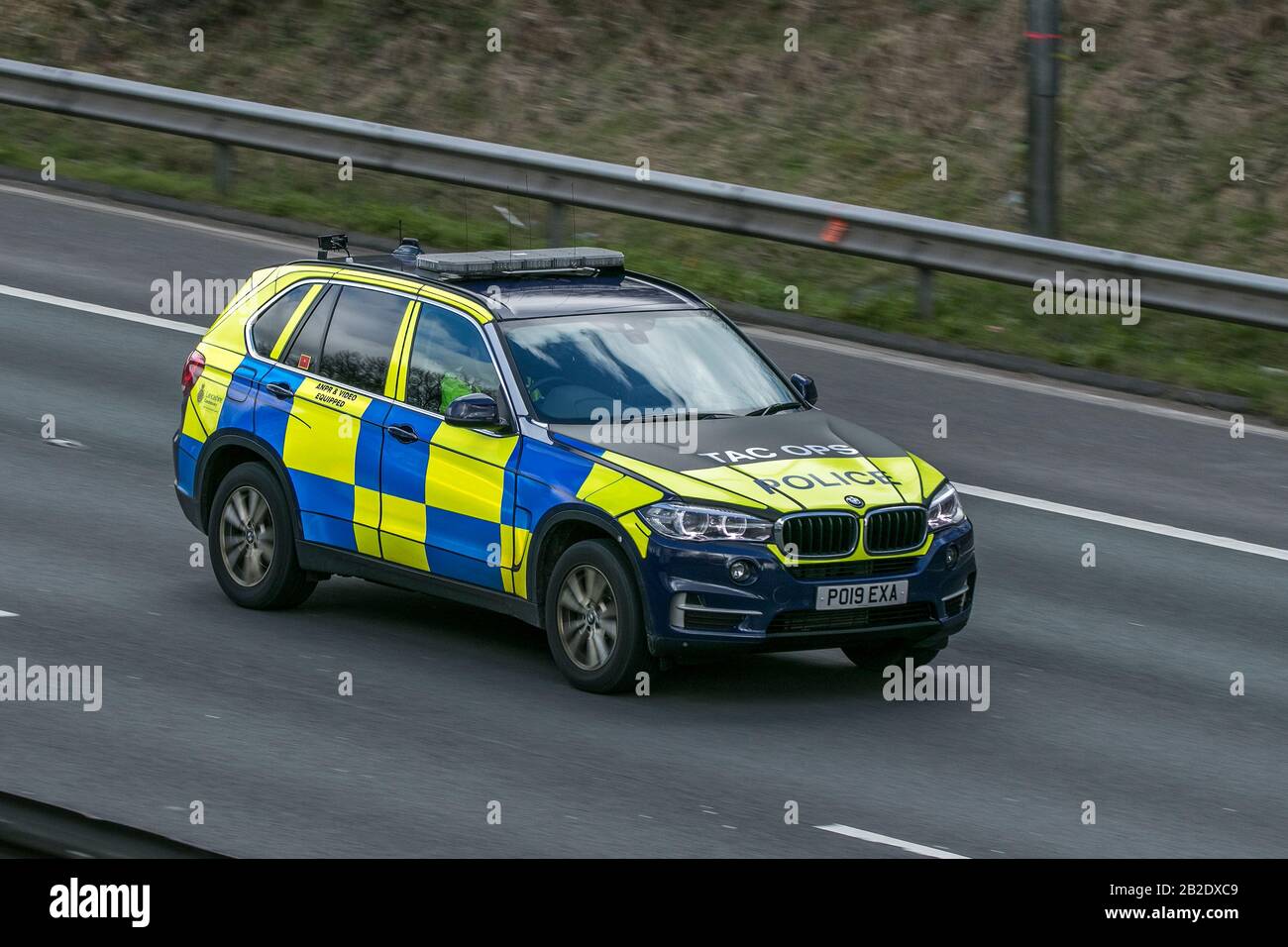 Police car emergency services vehicles driving on the M6 motorway near Preston in Lancashire, UK