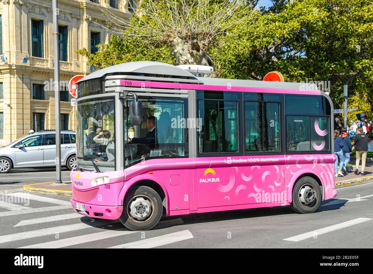 CANNES, FRANCE APRIL 2019 Small electric bus operated by Palm Bus driving in in the centre of