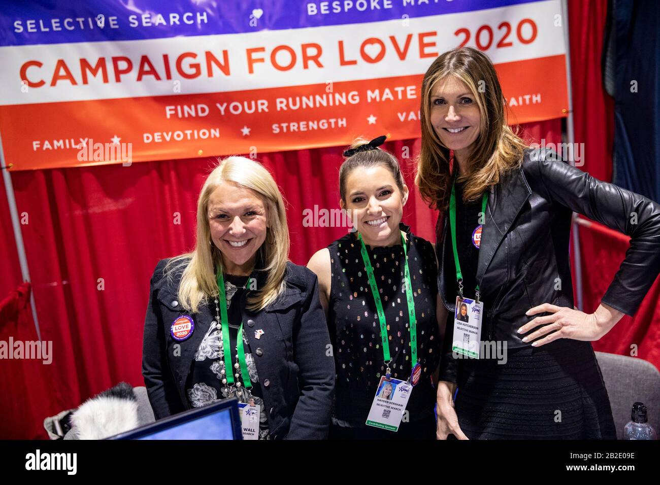 Oxon Hill, Md. 27th Feb, 2020. OXON HILL, Md. - FEBRUARY 27: Match makers with Campaign for Love pose for a photo in their booth at the Conservative Political Action Conference, CPAC 2020, in Oxon Hill, Md., on Thursday, February 27, 2020. Campaign for Love is a bespoke match making service who‚Äôs packages can from anywhere from $50,000 to $500,000.Credit: Samuel Corum/CNP (RESTRICTION: NO New York or New Jersey Newspapers or newspapers within a 75 mile radius of New York City) | usage worldwide Credit: dpa/Alamy Live News Stock Photo