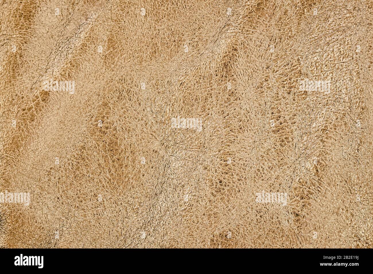 Natural crumpled leather texture, golden colored background Stock Photo