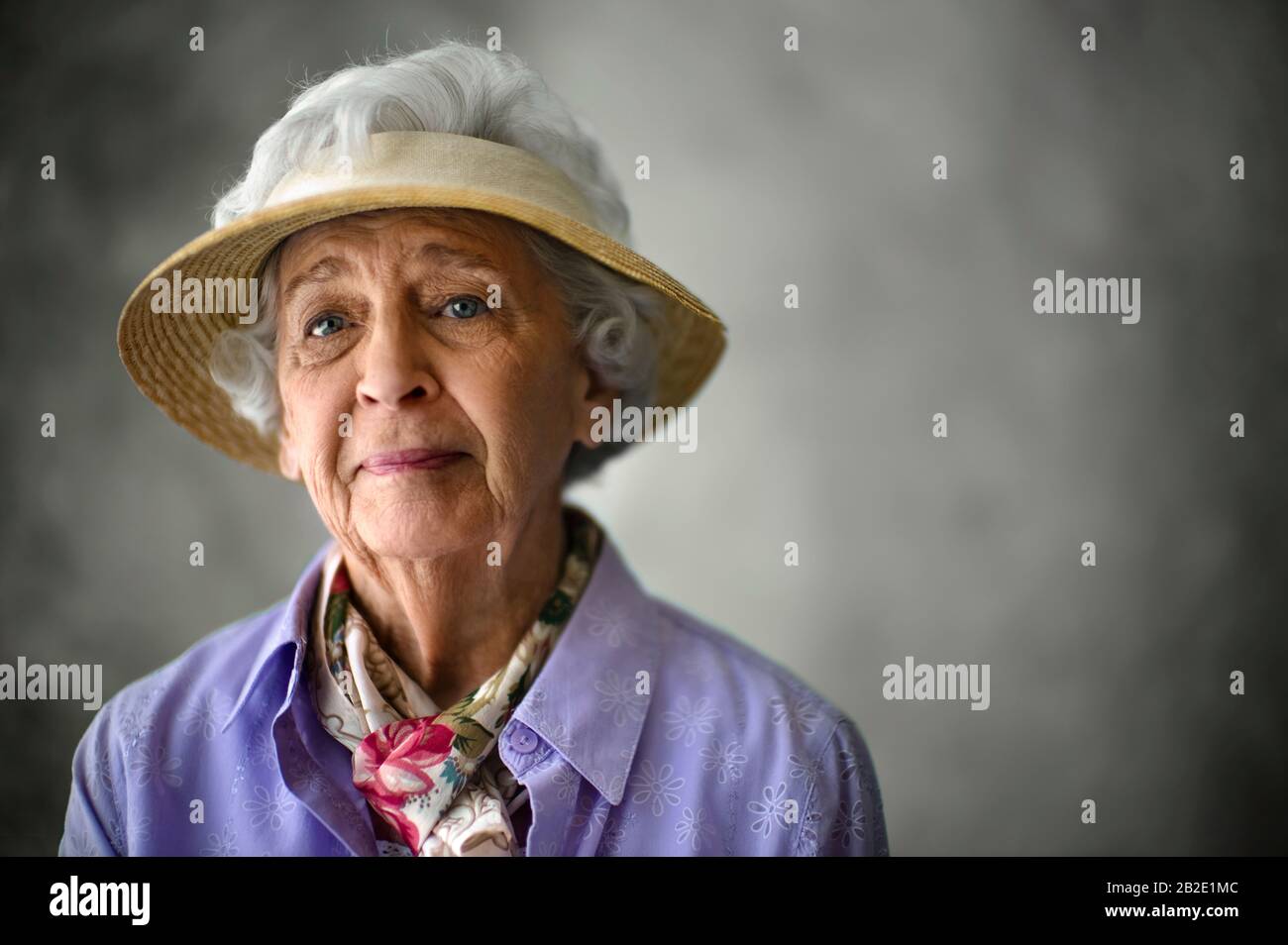 Portrait of an elderly woman wearing a sun hat Stock Photo