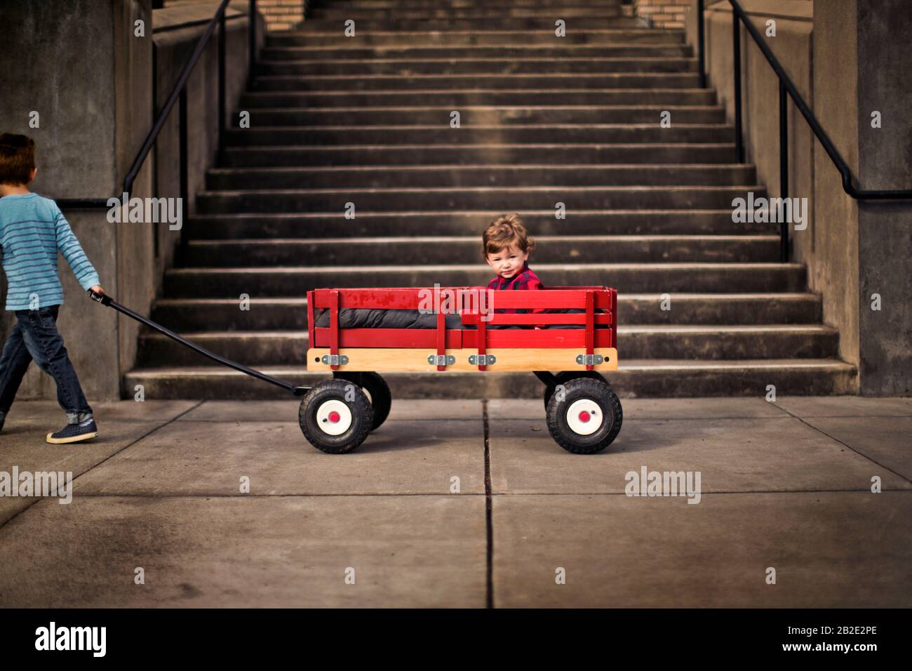 Boy pulling wagon hi-res stock photography and images - Alamy