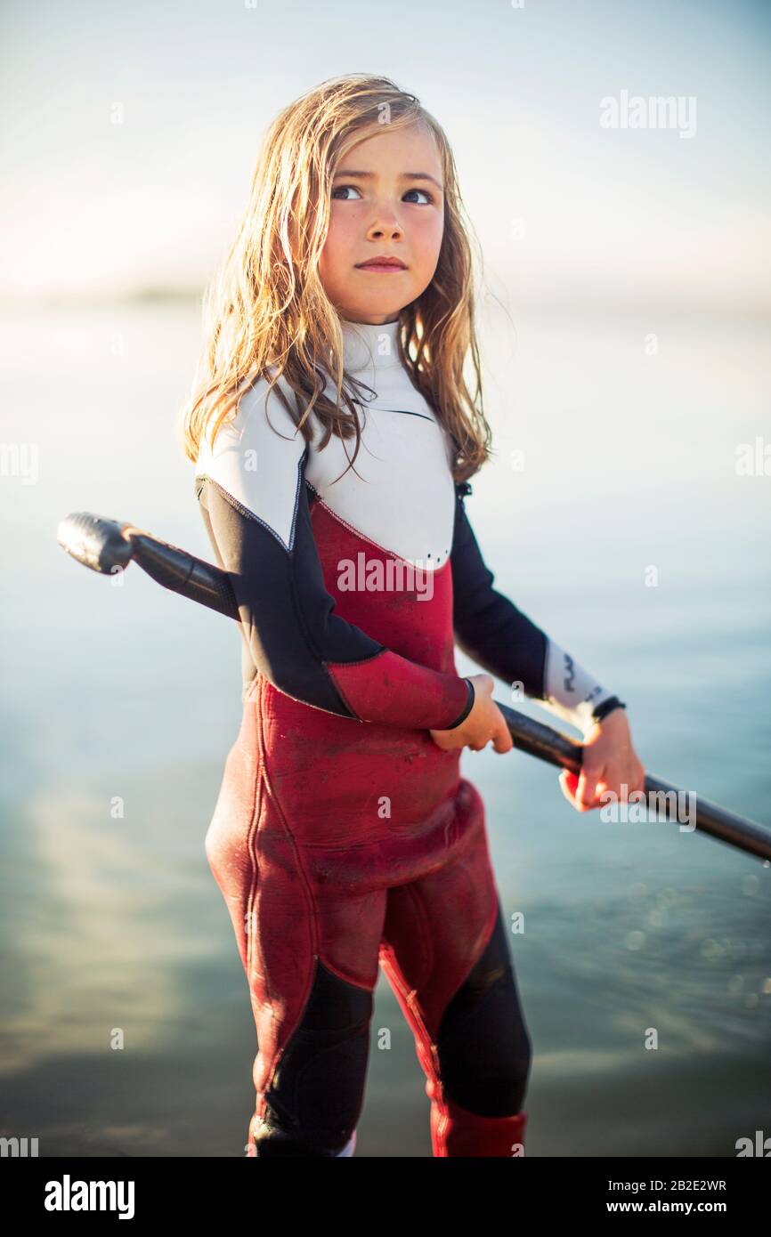 Young girl at the beach wearing a wetsuit Stock Photo Alamy