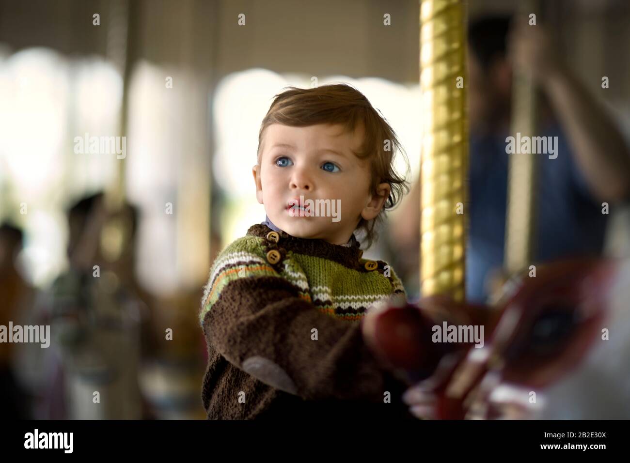 Young boy on a carousel ride at a carnival Stock Photo