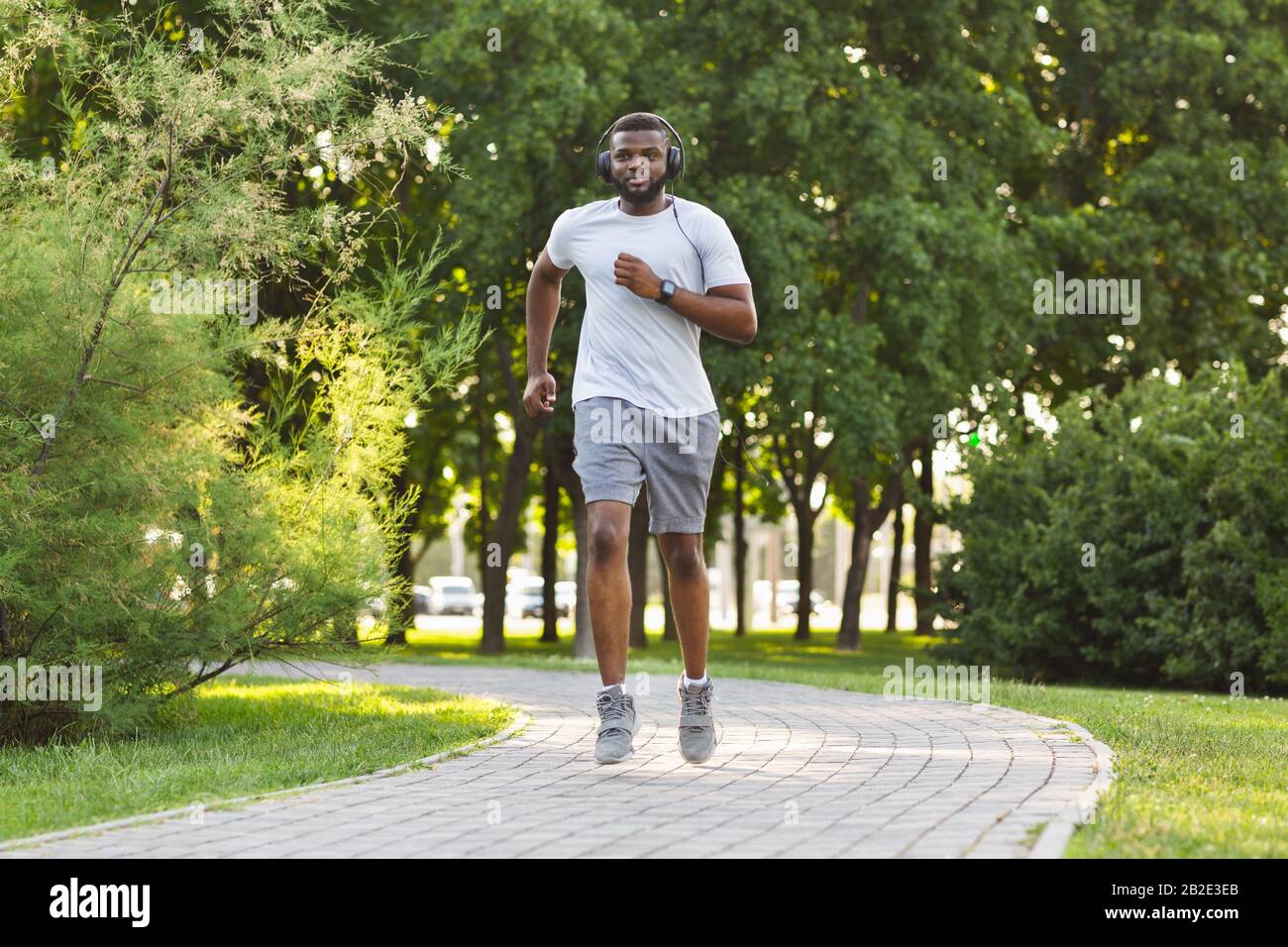 Sporty man jogging in a park stock photo