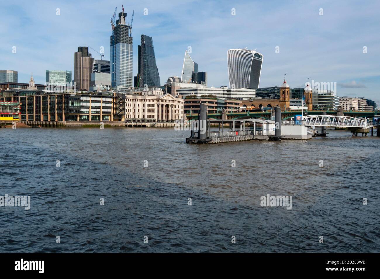 The London skyline is seen over the Thames, including 20 Fenchurch Street Tower and the Leadenhall Building. 22 Bishopsgate is under construction. Stock Photo