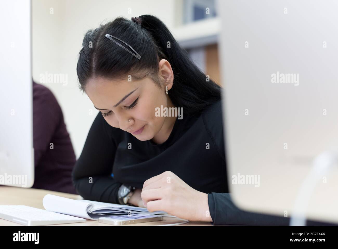 Beautiful female IT student working at her computer lab. Female student ...