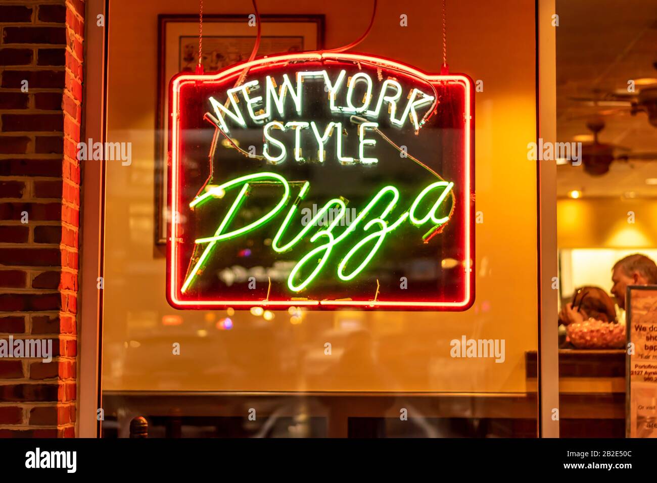 Chartotte, NC USA - January 3, 2020:  Horizontal, medium closeup of 'New York Style Pizza' neon brand and logo window signage. Stock Photo