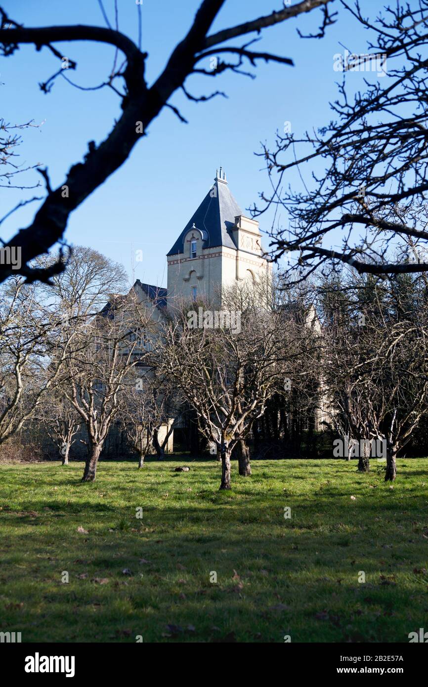 Fairfield Hall, a luxury apartment block housed in a former Victorian asylum, seen across the orchard planted by patients. Fairfield, Bedfordshire, UK Stock Photo