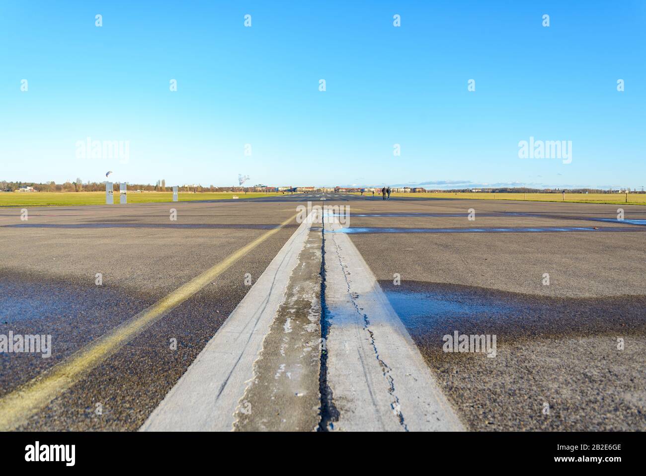 Cracking asphalt road, airport runway or airfield at Tempelhof Field park, former airport, in Berlin, Germany. Stock Photo