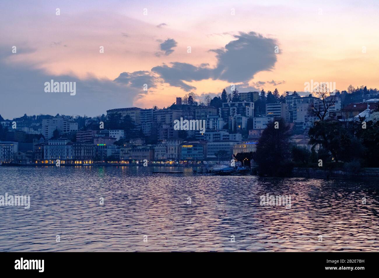 View across Lake Lugano at dusk in the spring of 2019. Stock Photo